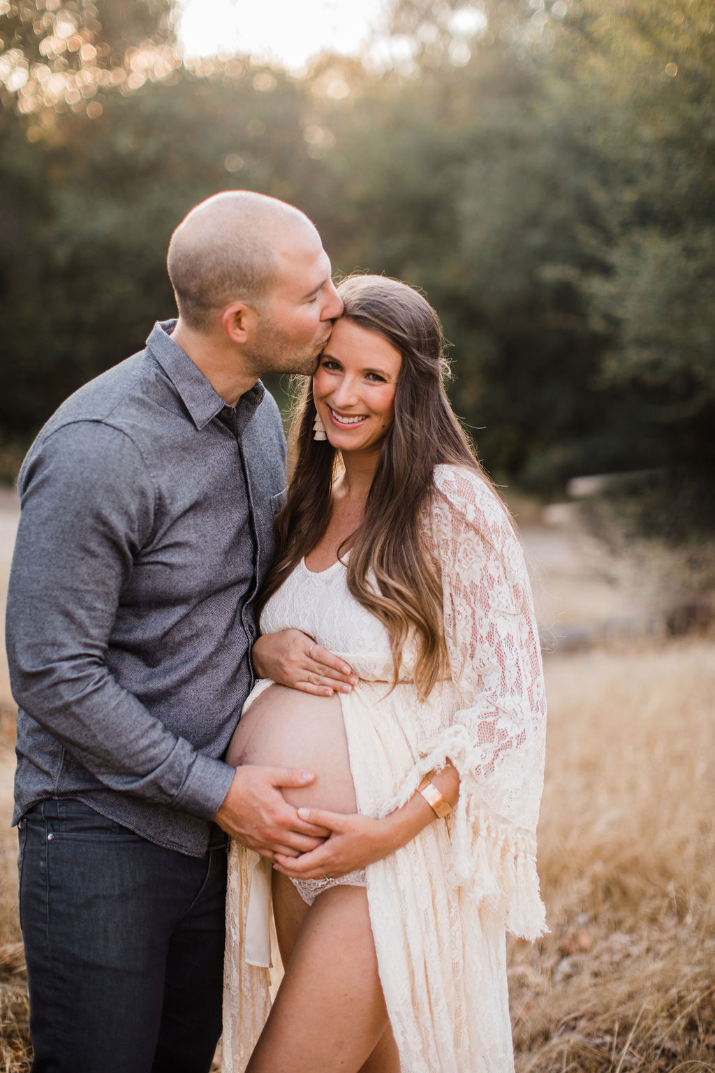 Dr. Leah Gordon with her husband, his hand on her pregnant belly