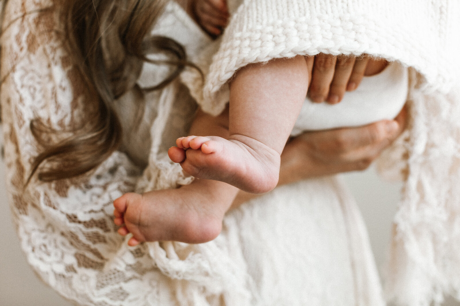 A mother holding her baby's feet